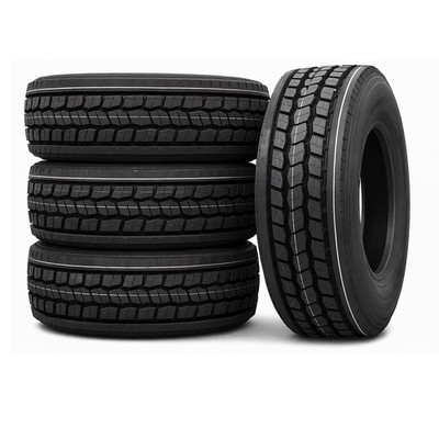 Three stacked truck tires beside an upright truck tire